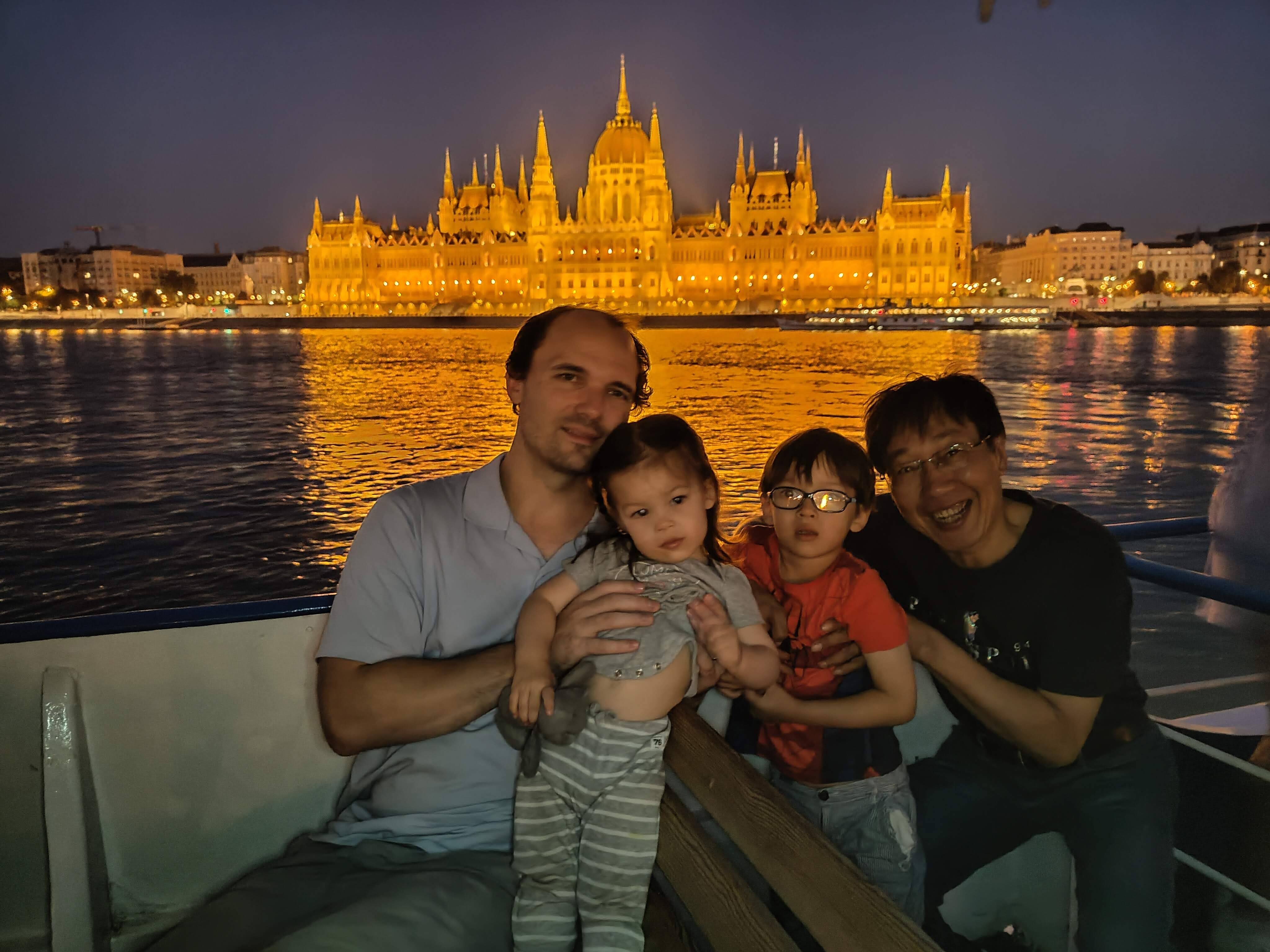 Our family on the Danube at night, with the illuminated Hungarian Parliament behind us.