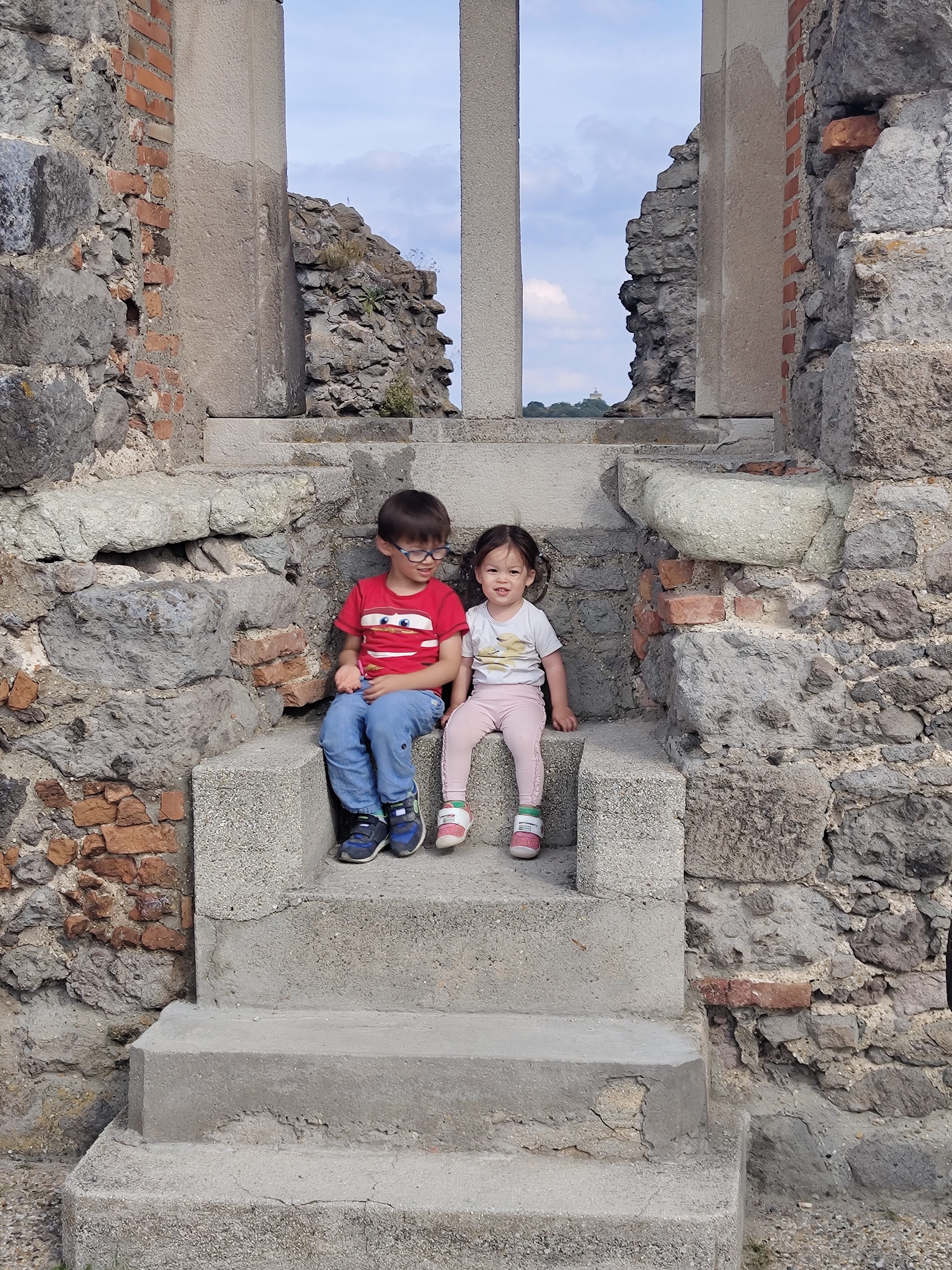 My son and daughter sitting together after we reached the top in Visegrad, the kind of quiet pause that made the climb feel worthwhile.