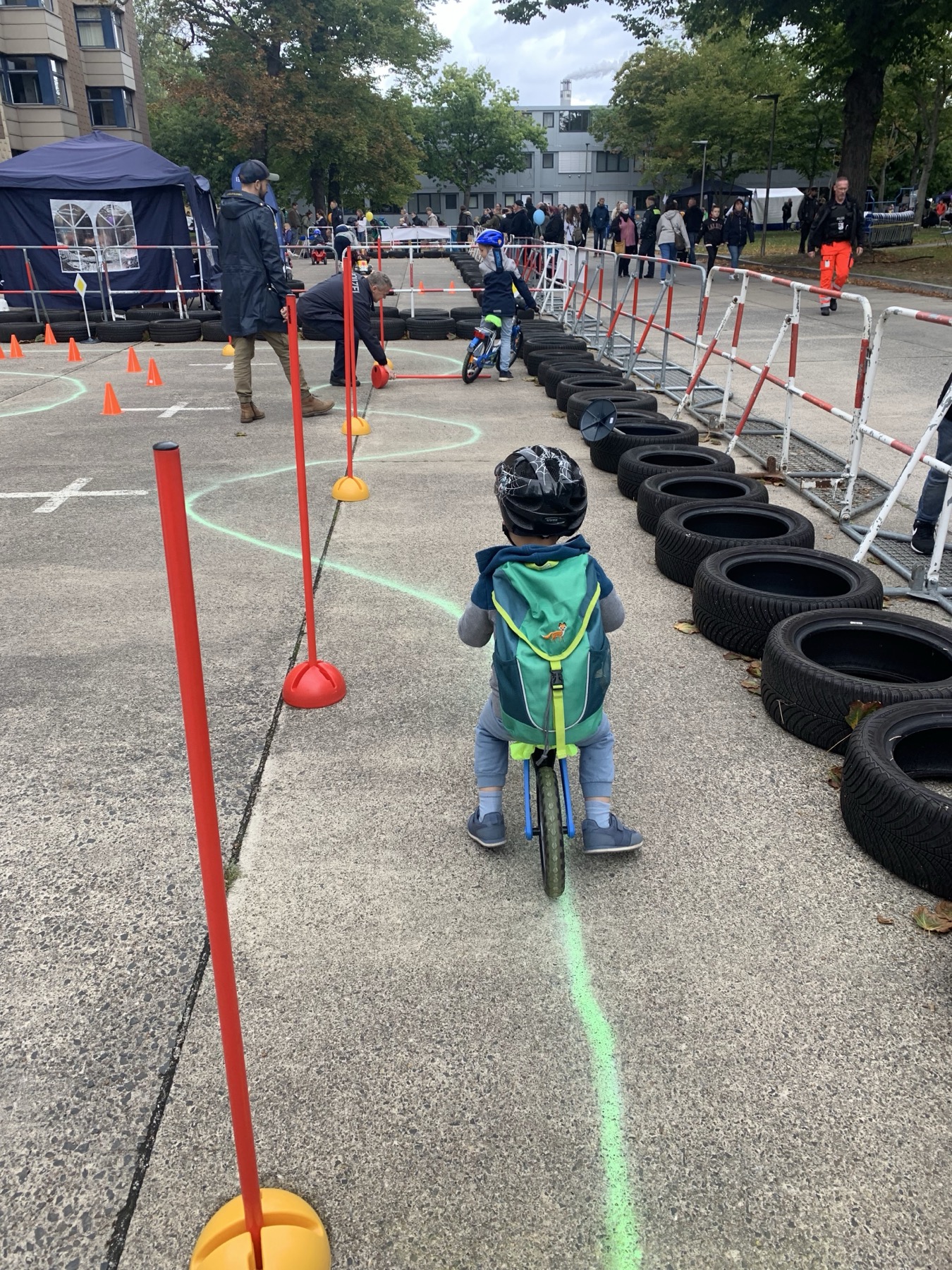 My son wearing a blue helmet while practising on a bike course.
