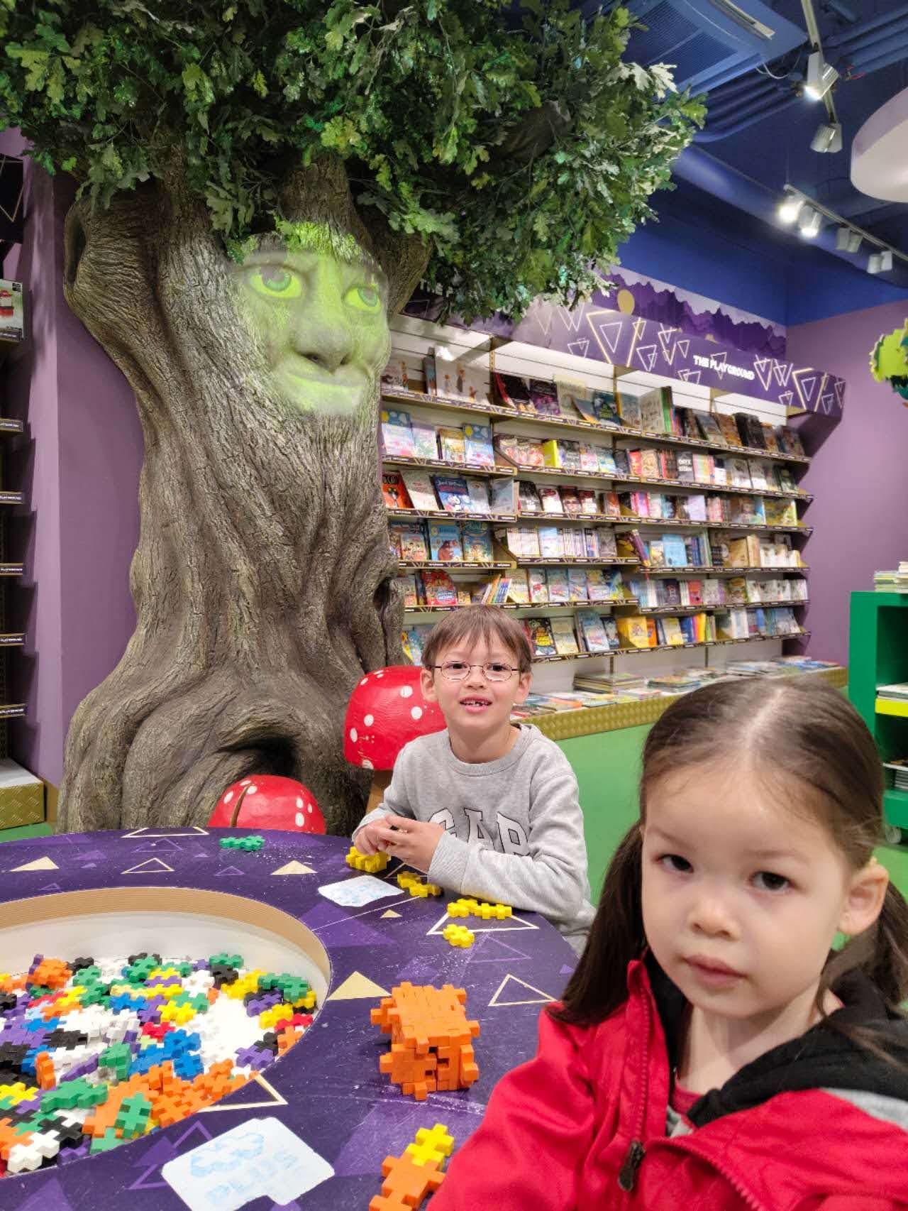 The children playing inside an indoor toy-store play area in Prague, our most useful rainy-day backup at the end of the trip.
