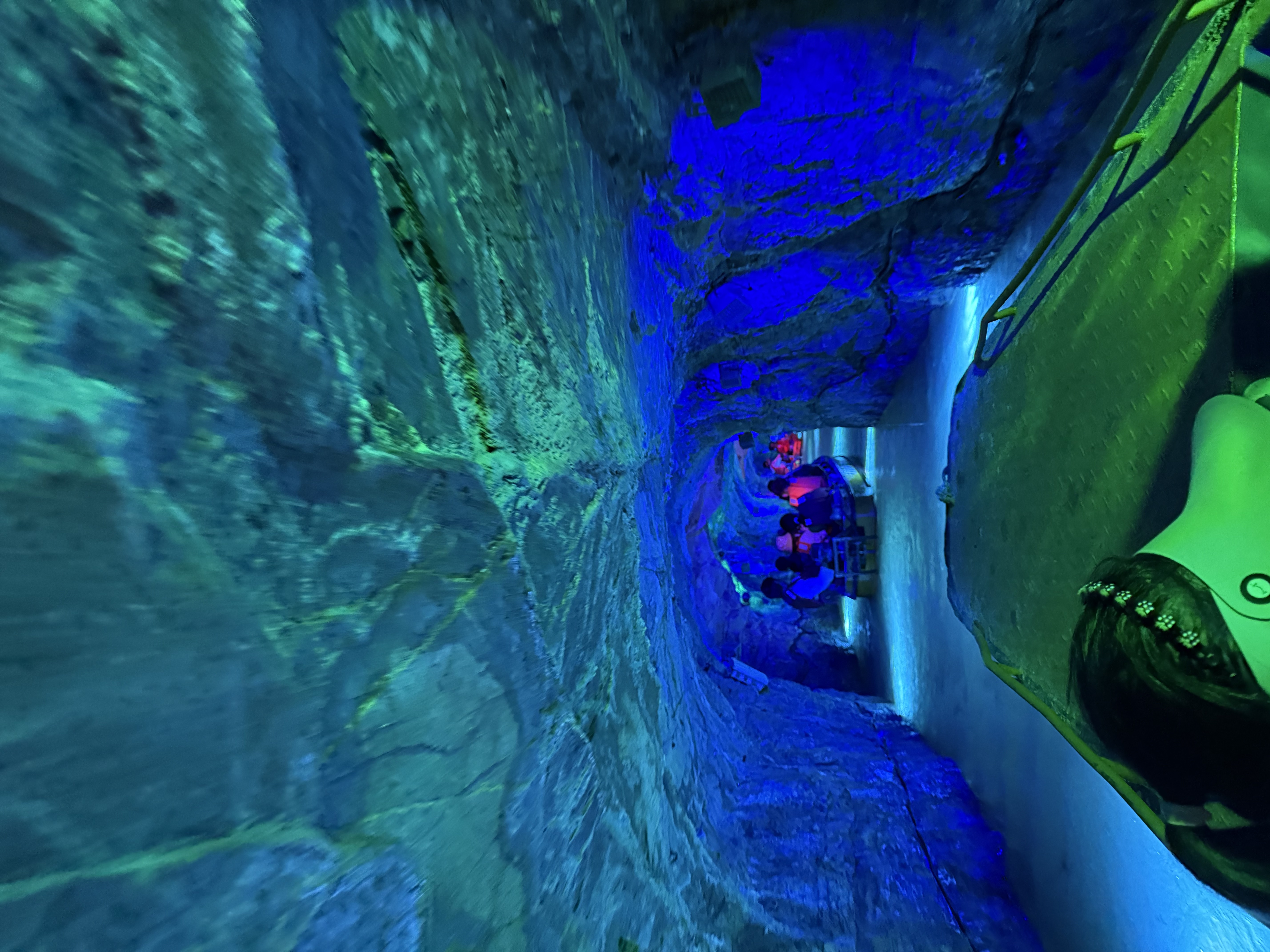 The bow of our boat beneath the blue-lit ceiling of Tianhetan’s water cave.
